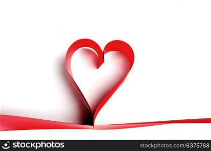Heart from red ribbon isolated on white background. Ribbon heart