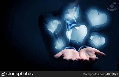 Heart glass icons in palm. Close up of businesswoman hand holding digital icon in palm