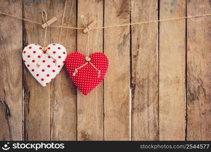 Heart hanging on wood background with copy space.