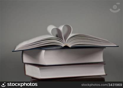 Heart in book on gray