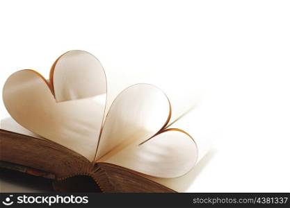 Heart made of blank pages inside a book on white background