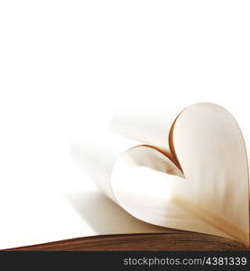 Heart made of blank pages inside a book on white background