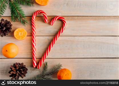 Heart made of Christmas candies on wooden background. Festive concept for greeting card. Place for text.. Heart made of Christmas candies on wooden background. Festive concept for greeting card.