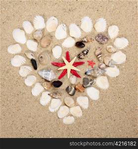 heart made with shells. Heart shape on sand