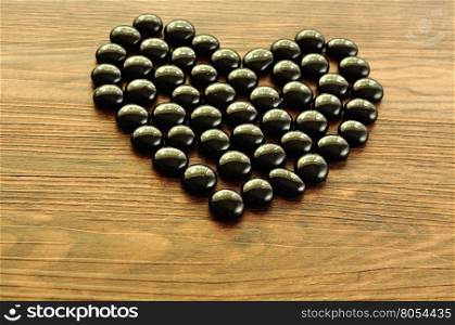 Heart make out of black pebbles