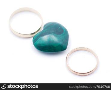 heart of malachite and wedding rings on a white background