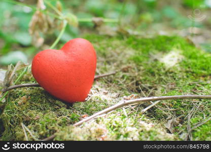 Heart of red thread on an old tree stump with moss. Love concept.. Heart of red thread on an old tree stump. Love concept