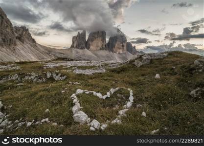 heart of stones in front of big 3 peaks of Lavaredo