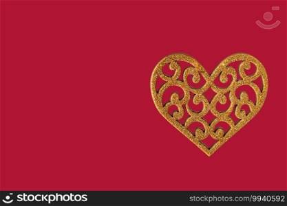 Heart of yellow color on a red background. View from above. Valentine’s Day. Romance. Copy space on the left.. Heart of yellow color on a red background. View from above. Valentine’s Day. Romance.