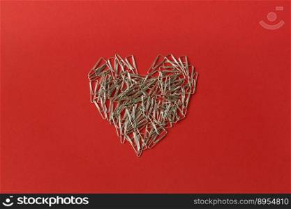Heart on a red background. Valentine’s Day. Valentines day greeting card. Heart of paper clips. Stationery.. Heart on a red background. Valentine’s Day. Valentines day greeting card. Heart of paper clips. Stationery
