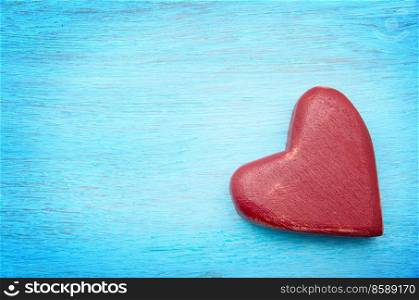 Heart on old shabby blue wooden background