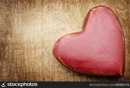 Heart on old shabby wooden background