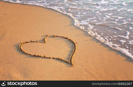 Heart on the beach. Romantic composition.