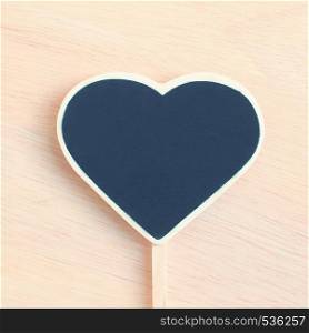 Heart shape blackboard on wood with retro filter effect