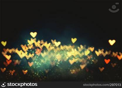 Heart shape bokeh from blurred light on black background. Love, wedding and valentine concept background.