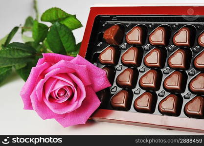 Heart shape chocolate and pink rose close up