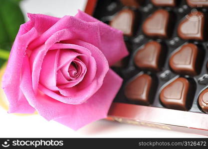 Heart shape chocolate and pink rose close up