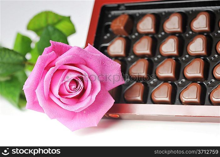 Heart shape chocolate and pink rose close up