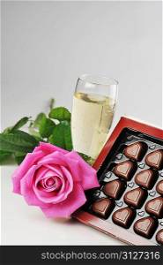 Heart shape chocolate, champagne and pink rose