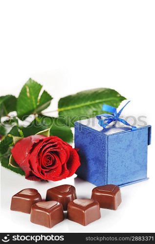 Heart shape chocolate, rose and gifts in box close-up