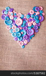 Heart shape from buttons over canvas textile