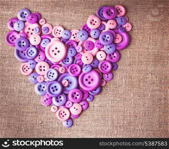 Heart shape from buttons over canvas textile
