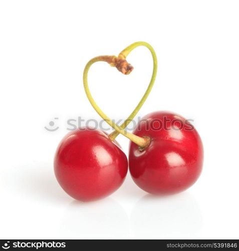 Heart shape from cherries with green leaves isolated on white
