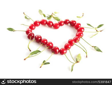 Heart shape from cherries with green leaves isolated on white