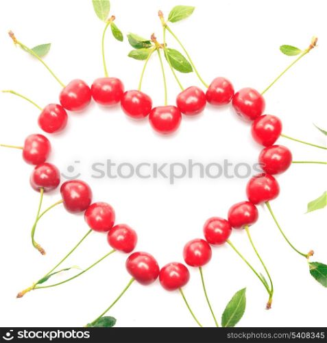 Heart shape from cherries with green leaves isolated on white