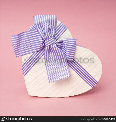 Heart shape gift box on a pink background