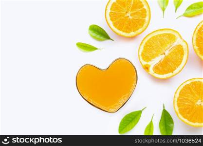 Heart shape glass of fresh orange juice with orange fruit on white background. Top view with copy space