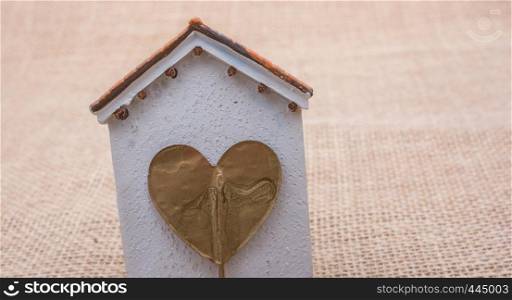 Heart shape icon placed on a little model house