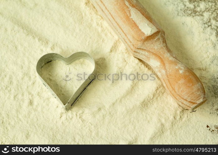 Heart shape in the sifted flour on the table