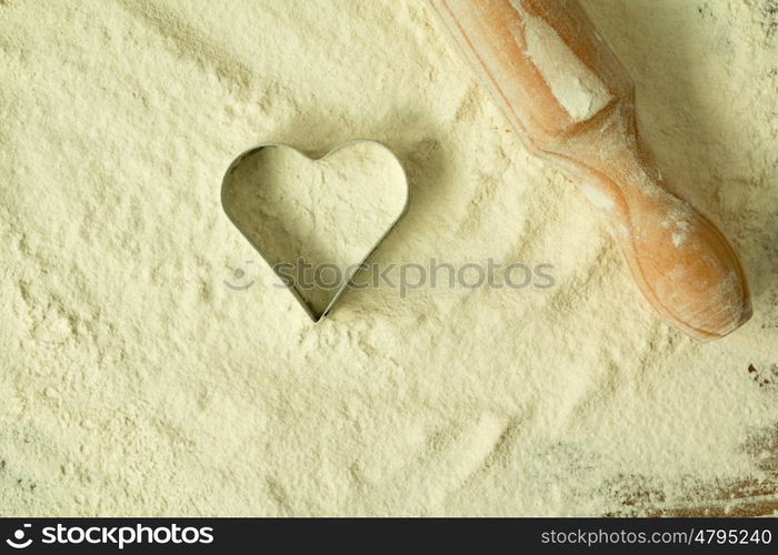 Heart shape in the sifted flour on the table