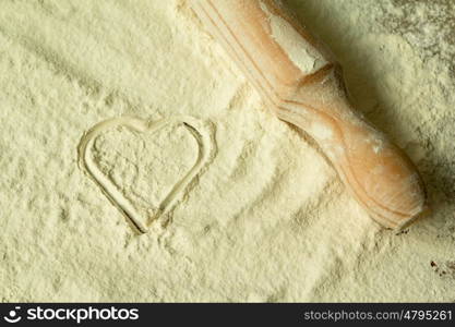 Heart shape in the sifted flour on the table