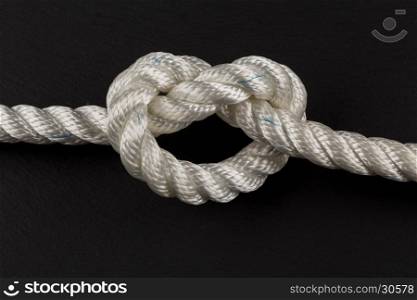 heart shape knot of rope on dark background