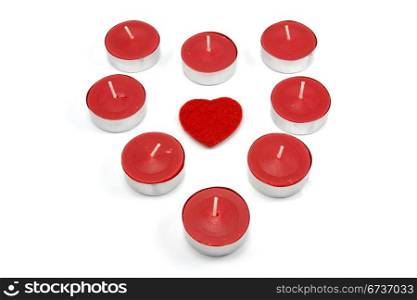 heart shape made from red candles. isolated on white