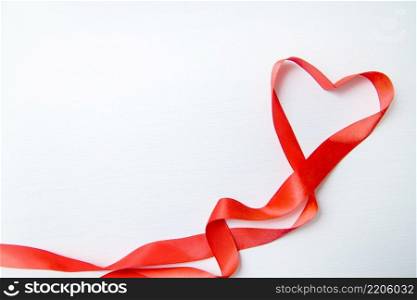 Heart shape made of red ribbon on white wooden Background. copy space Valentines and 8 March Mother Women’s Day concept. Heart shape made of red ribbon on white wooden Background. copy space - Valentines and 8 March Mother Women’s Day concept.