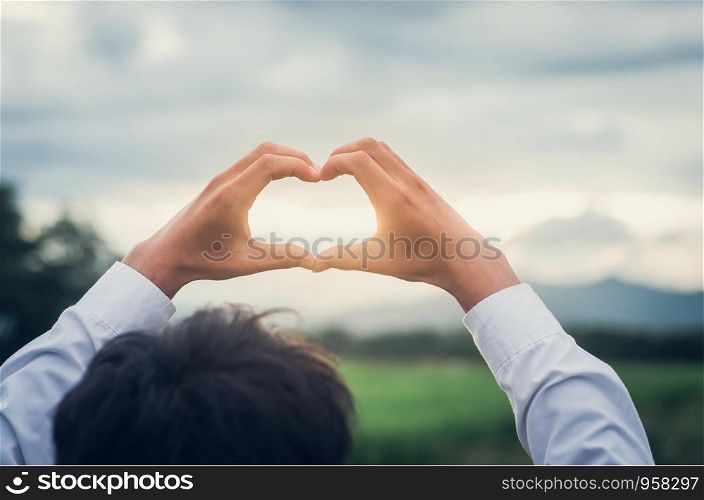 Heart shape made of two beautiful palms In a natural area Show love