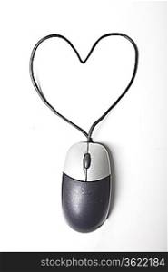 Heart shape made up of computer mouse wire over white background