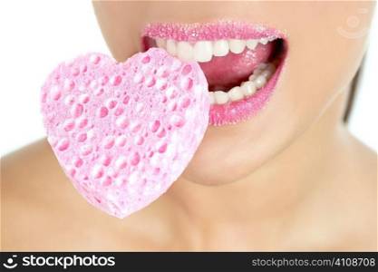 Heart shape makeup sponge on beautiful woman macro mouth