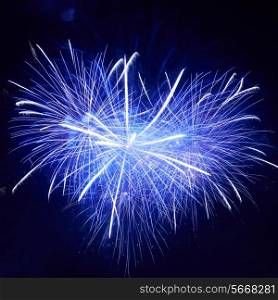 Heart shape of blue colorful fireworks on the black sky background