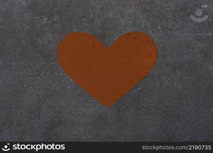 Heart shape of spreading cocoa powder on concrete background of table. Heart shape of spreading cocoa powder onc oncrete background