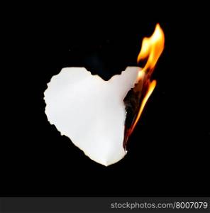 heart shape paper burning on black background