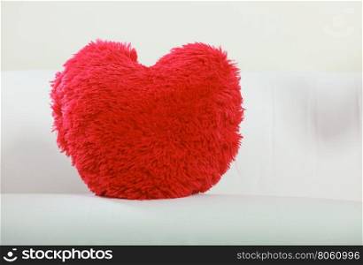 Heart shape pillow on sofa. Valentines day love.. Red heart shape pillow on sofa couch. Valentines day love.