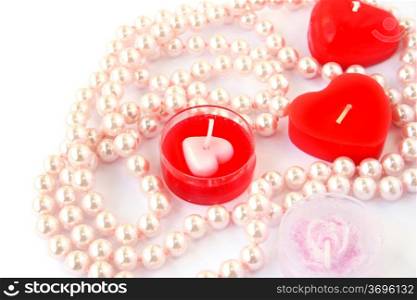 Heart shape red candles and necklace isolated on white background.
