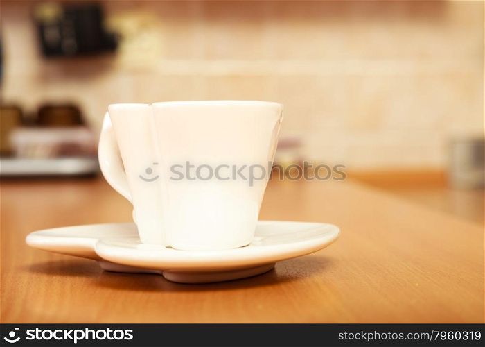 Heart shape white empty tea coffee cup mug on saucer plate on wooden board.. Empty tea coffee cup mug on saucer. Heart shape.