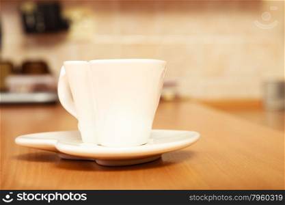 Heart shape white empty tea coffee cup mug on saucer plate on wooden board.. Empty tea coffee cup mug on saucer. Heart shape.
