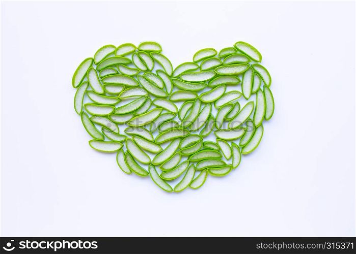 Heart shaped aloe vera slices on white background.