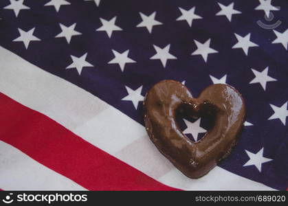 heart shaped biscuits and usa flag on wooden table - happy memorial day.. heart shaped biscuits and usa flag on wooden table happy memorial day.